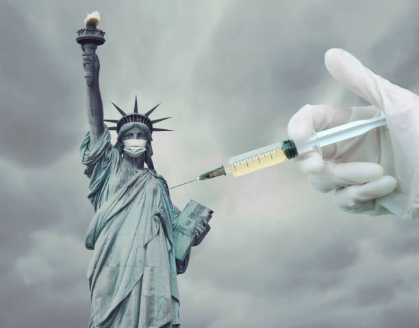 Concept of Covid 19 vaccination in New York, USA. Statue of liberty with a mask being vaccinated against SARS CoV 2 stock photo