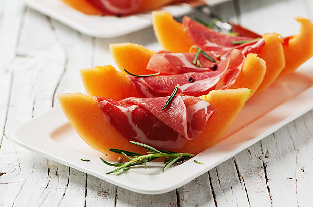 Concept of italian food Concept of italian food with melon and prosciutto, selective focus prosciutto stock pictures, royalty-free photos & images