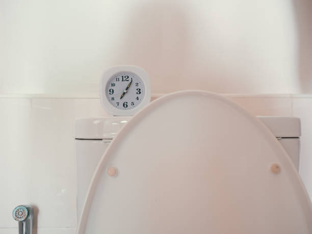 Concept of life routine with clock in the bathroom. stock photo