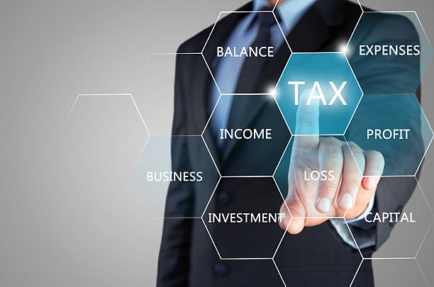 Concept of online taxation on touch screen Mid section view of a businessman hand touching tax word on virtual screen the concept of online taxation. corporate tax stock pictures, royalty-free photos & images