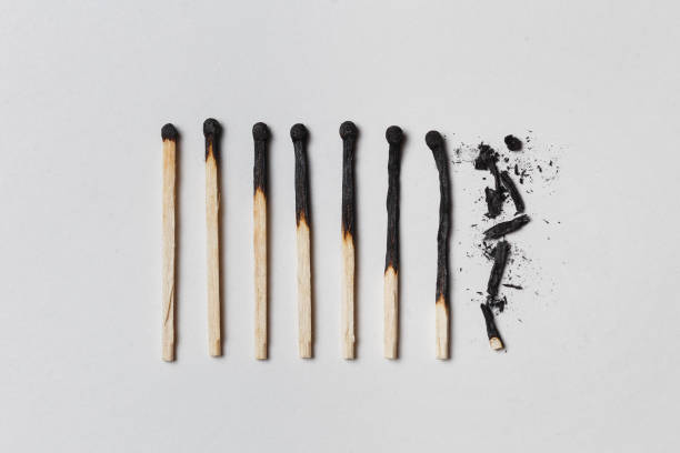 Concept of patience. A row of burnt matches, from left to right, from almost a whole match to a completely burnt match to the dust. stock photo