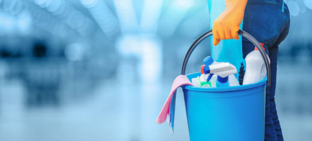 Concept of quality cleaning. Concept of quality cleaning. The cleaning lady standing with a bucket and cleaning products. cleaner photos stock pictures, royalty-free photos & images