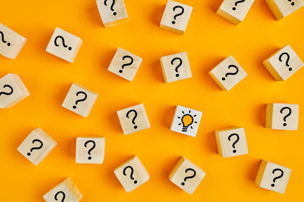 Concept of to find a creative idea or problem solving. Question mark and light bulb icons on wooden cubes Concept of to find a creative idea or problem solving. Question mark and light bulb icons on wooden cubes on yellow background. question mark stock pictures, royalty-free photos & images