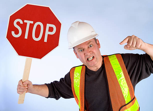 Conceptual Construction Worker Asking to Stop Doing Something stock photo