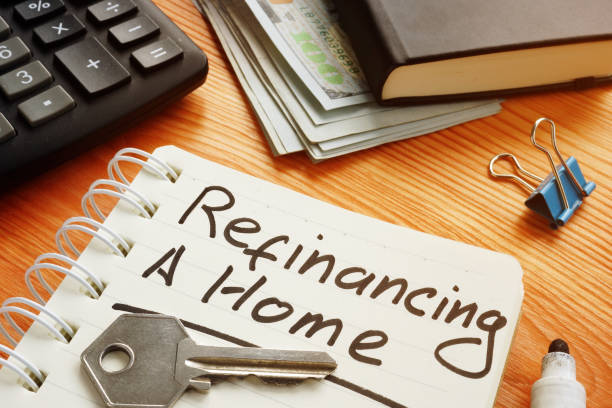 Conceptual photo is showing printed text refinancing a home stock photo
