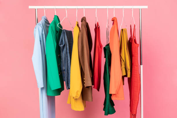 Conceptual Shot Of Clothing Rail With Trendy Clothes, Pink Background Shopping. Conceptual Shot Of Clothing Rail With Trendy Clothes Over Pink Background In Studio. Colorful Outfits Hanging On Hangers. Fashion And Style, Stylish Wardrobe Concept clothes rack stock pictures, royalty-free photos & images