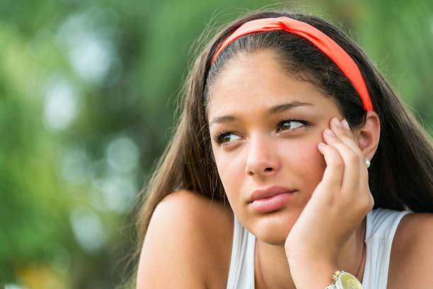 Concerned teenage girl Concerned Beautiful hispanic teenage girl looking away cute puerto rican girls stock pictures, royalty-free photos & images