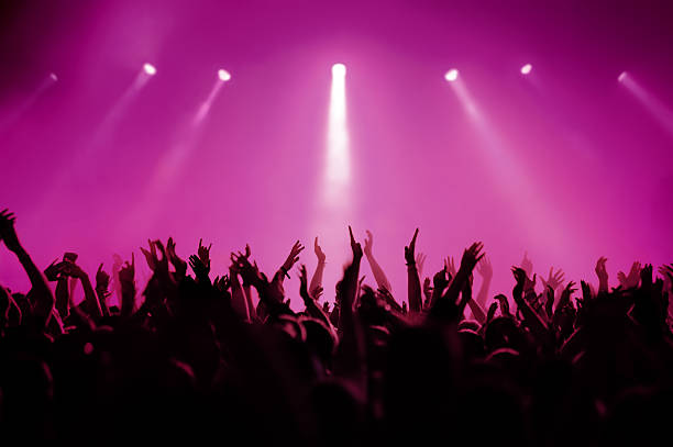 concert in pink silhouettes of people on a rock concert raising hands magenta stock pictures, royalty-free photos & images