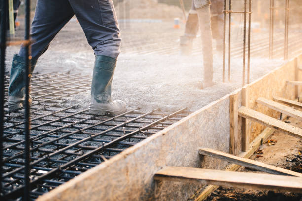 Concrete pouring during commercial concreting floors of buildings in construction stock photo