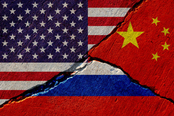 concrete wall with painted united states, china and russia flags stock photo