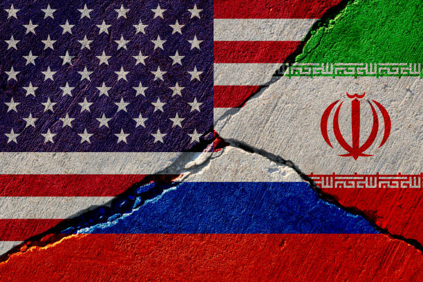 concrete wall with painted united states, russia and iran flags stock photo