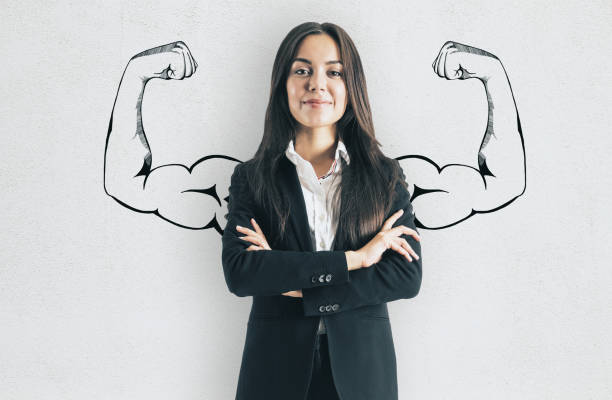 Confidence and strength concept Portrait of attractive young european businesswoman with drawn muscly arms. Confidence and strength concept muscular build stock pictures, royalty-free photos & images