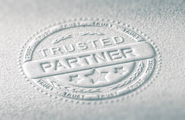 Confidence in Business 3D illustration of an embossed stamp with the text trusted partner, Paper background and blur effect. Concept of confidence in business relationship. relief emotion stock pictures, royalty-free photos & images