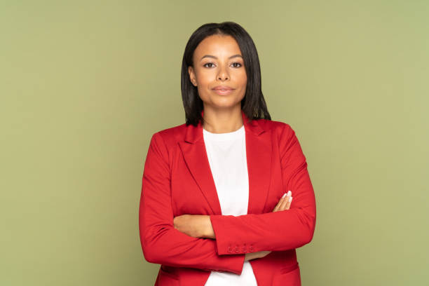 Confident african businesswoman with folded hands. Successful young entrepreneur or female leader stock photo