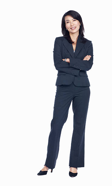 Confident business woman Full length of Asian business woman with arms crossed over white background whole stock pictures, royalty-free photos & images
