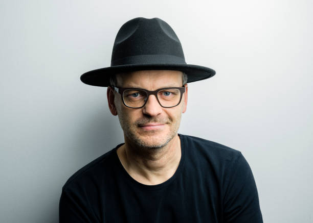 Confident mature man with eyeglasses and hat stock photo