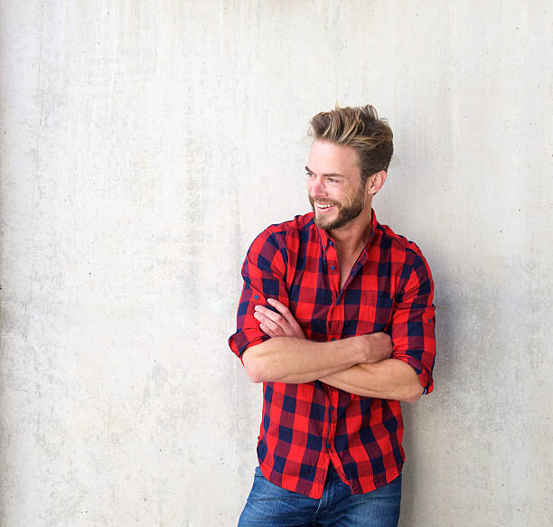 Confident smiling man posing with arms crossed Portrait of a confident smiling man posing with arms crossed plaid shirt stock pictures, royalty-free photos & images