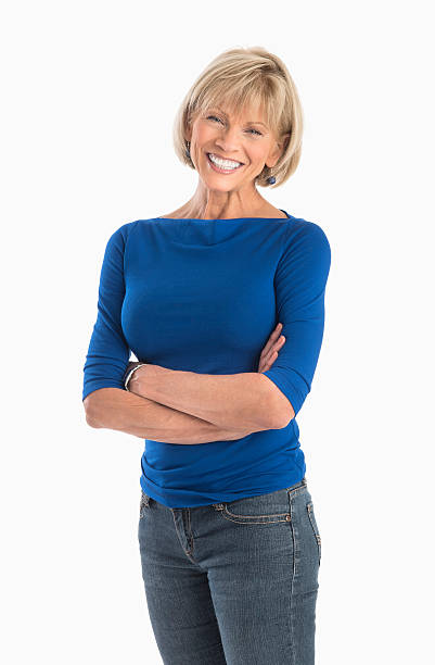 Confident Woman Standing Arms Crossed Over White Background stock photo