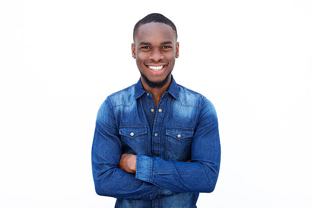 Confident young african guy Portrait of a confident young african guy smiling with arms crossed against white background 20 29 years stock pictures, royalty-free photos & images