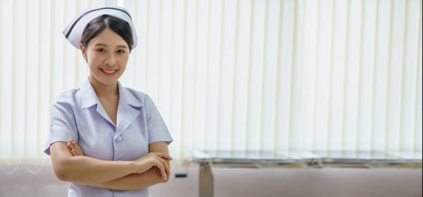 confident young asian thai nurse on indoor hospital background with copy space . banner and panoramic stock photo