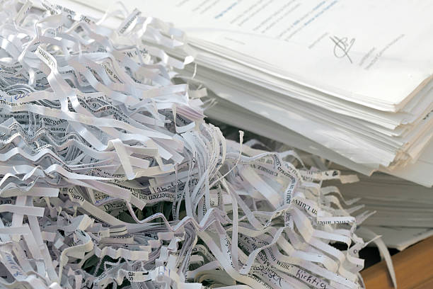 Confidential documents being shredded Shredded documents destruction stock pictures, royalty-free photos & images
