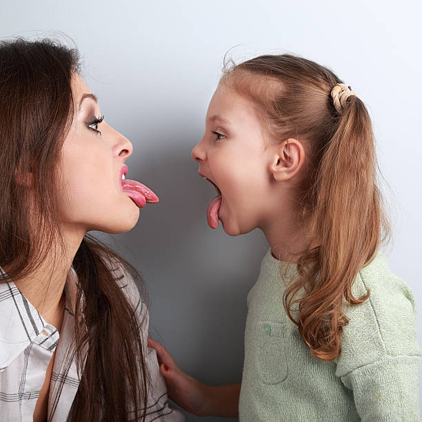 Conflicting funny mother and daughter disputing stock photo