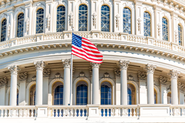 US Congress dome with American flag waving in Washington DC on capitol hill national mall closeup stock photo