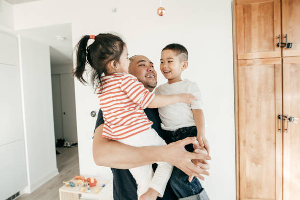 Connected parenting Dad hugging kids fathers day stock pictures, royalty-free photos & images