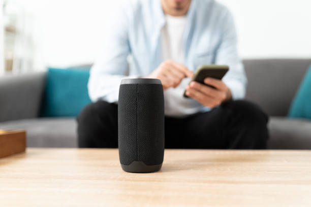 Connecting a phone and smart speaker Closeup of a man connecting his smartphone and bluetooth speaker to his smart home system bluetooth stock pictures, royalty-free photos & images