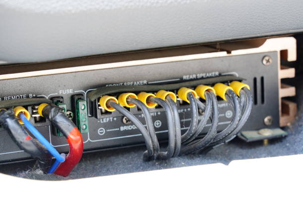 Connecting a wiring to car amplifier stock photo