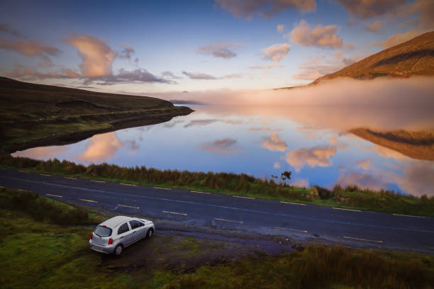 Connemara road early in the morning. Travel Destinations in Ireland Car on the Connemara tourist route wild atlantic way stock pictures, royalty-free photos & images