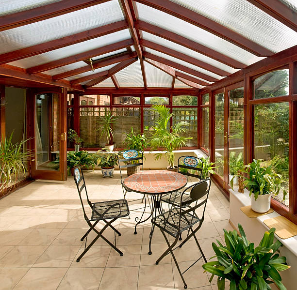 conservatory conservatory tables chairs plants room in house next to garden greenhouse table stock pictures, royalty-free photos & images