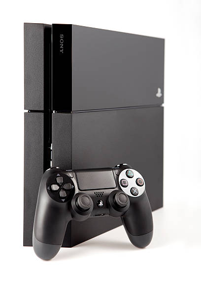 Console Playstation 4 and pad Dualshock on white background stock photo
