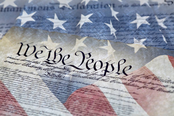 Constitution of the United States Close up of We the People of the Constitution of the United States of America and the Declaration of Independence with shallow depth of field democracy stock pictures, royalty-free photos & images