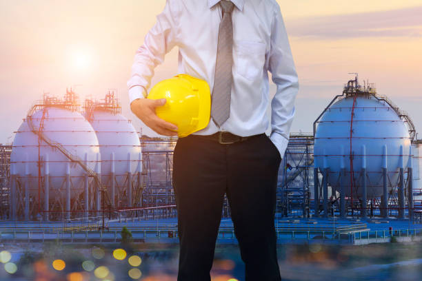 Construction concept . engineer  holding helmet and blur construction background . Occupational health and safety . stock photo