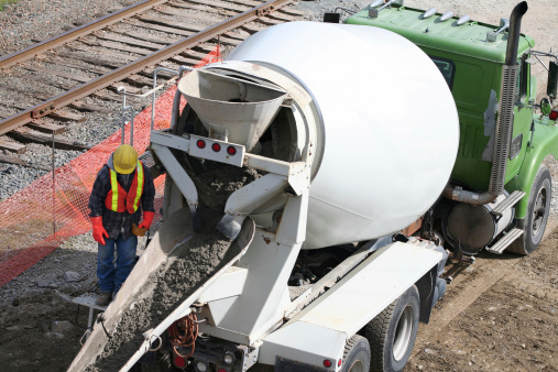 Construction Industry Cement Truck Pouring Concrete At Job Site Stock
