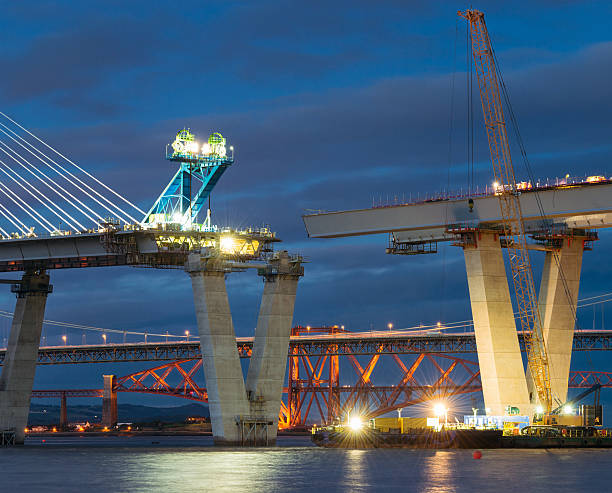 Construction of the Queensferry Crossing over the Firth of Forth Construction ongoing at night on the new bridge crossing the Firth of Forth, between Fife and the Lothians. bridge built structure photos stock pictures, royalty-free photos & images
