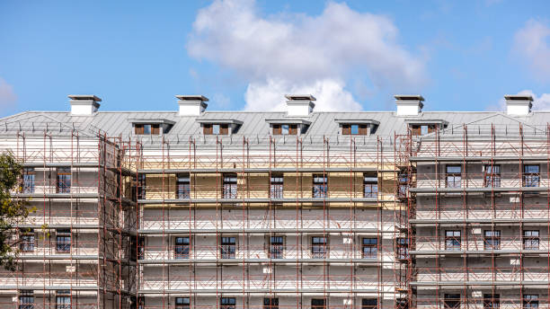 construction scaffolding on multistory building facade during renovation stock photo