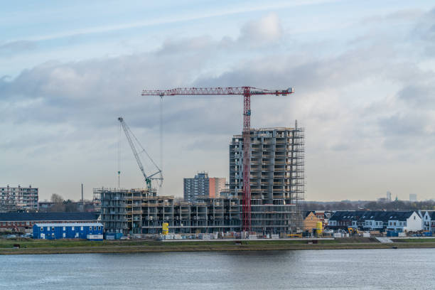 Construction site during the day at the edge of a lake or bank of a river. stock photo