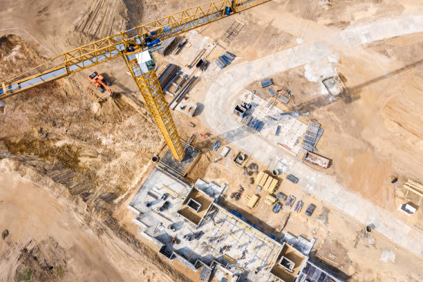 construction site with crane and apartment building under construction stock photo