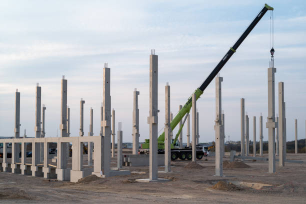 Construction site with heavy duty crane and concrete pillar stock photo