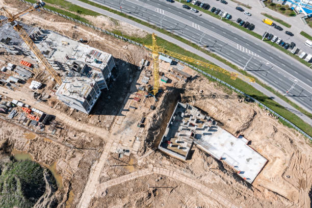 construction site. yellow crane near apartment buildings under construction. stock photo