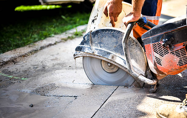 Construction worker cutting Asphalt paving for sidewalk stock photo