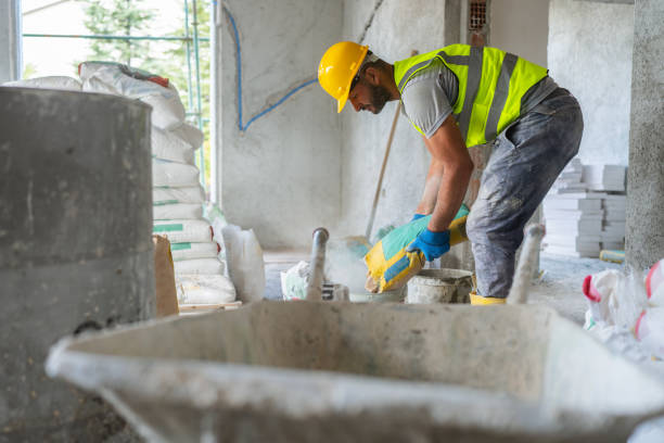 Construction worker mixing grout stock photo