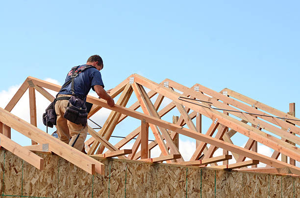Construction worker piecing together a house frame stock photo