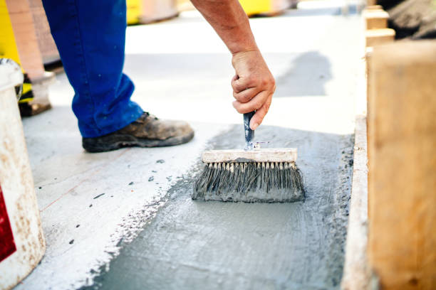 construction worker using brush and primer for hydroisolating and waterproofing house stock photo