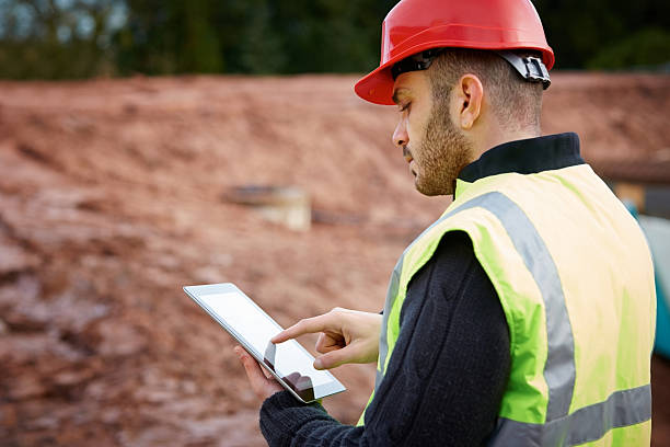 Construction worker using tablet PC stock photo