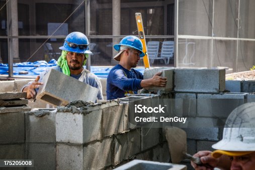 istock Construction Workers Building Concrete Block Wall 175205008