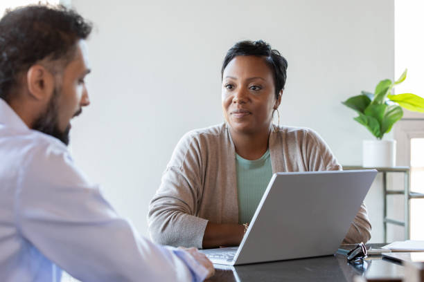Consultant Talking With Client at a meeting stock photo