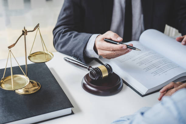 Consultation and conference of Male lawyers and professional businesswoman working and discussion having at law firm in office. Concepts of law, Judge gavel with scales of justice stock photo
